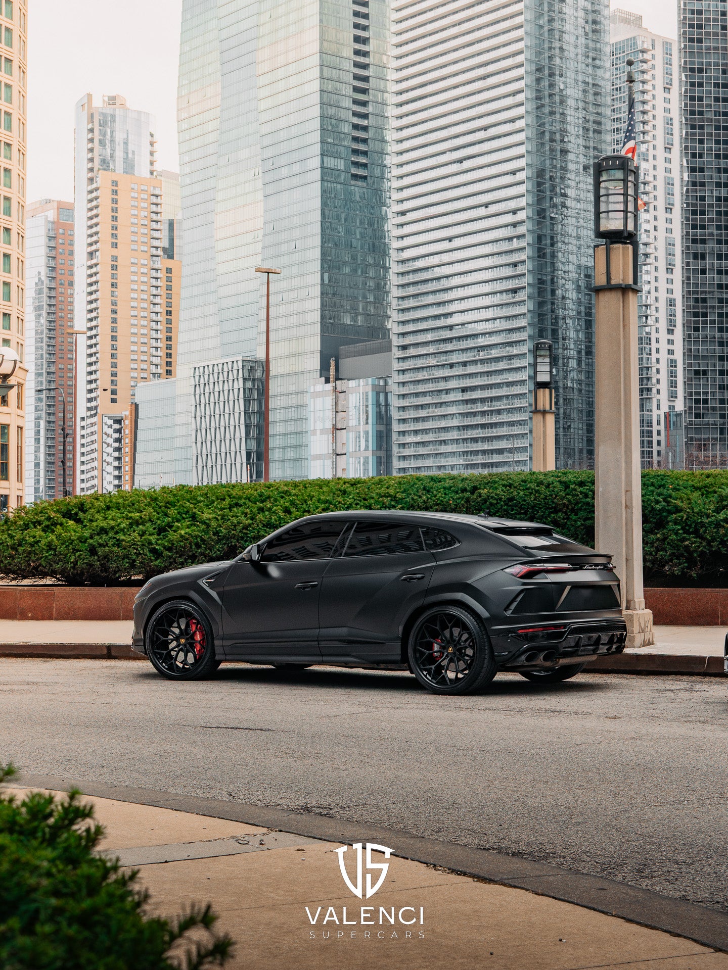 Lamborghini Urus driver-side view showcasing sleek black exterior, sharp aerodynamic lines, and bold luxury SUV design.